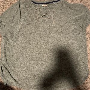 new pale green shirt with crossed strings on front